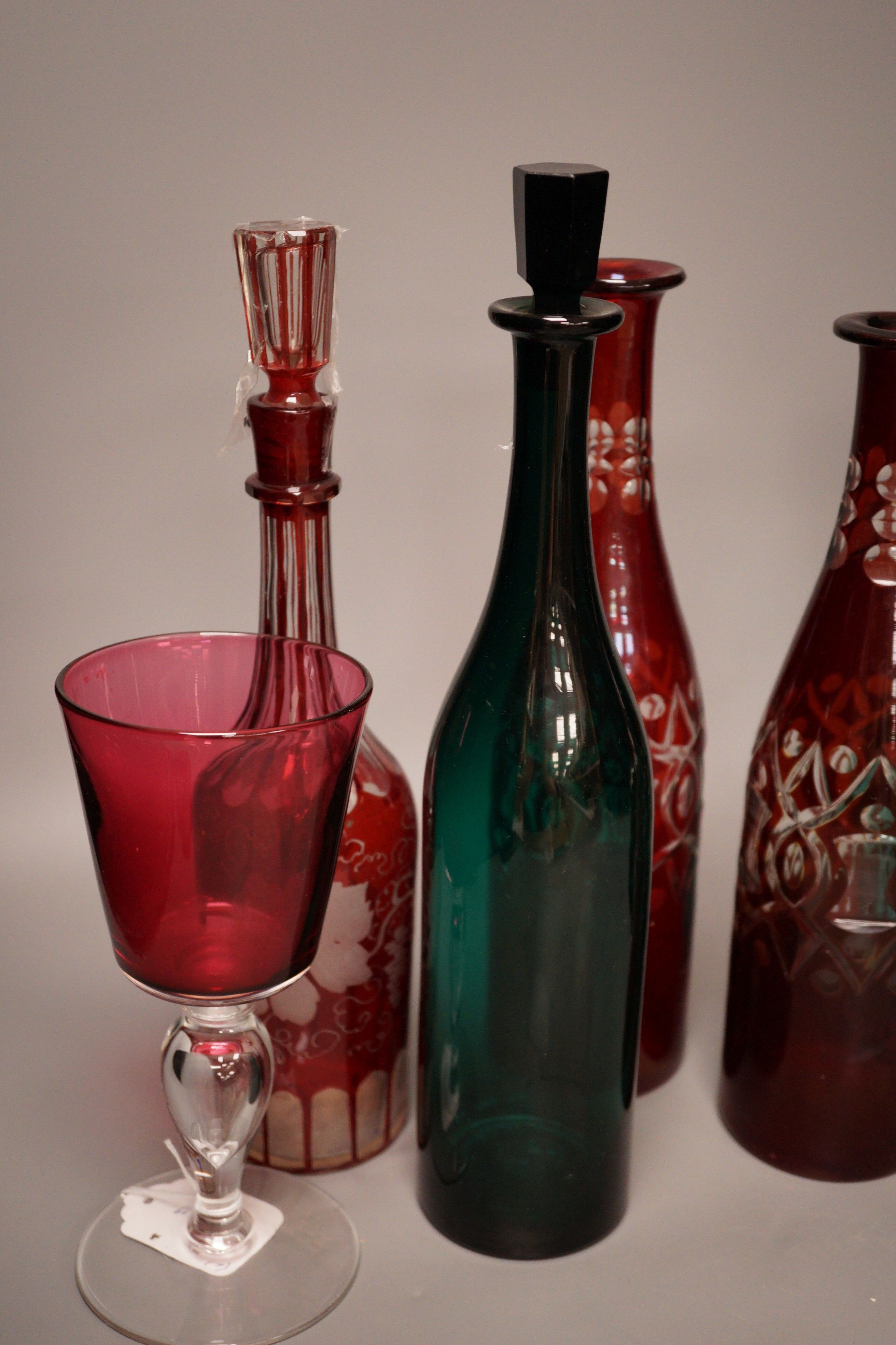 A pair of cut ruby flashed glass decanters, late Georgian emerald green glass decanter, and four other items